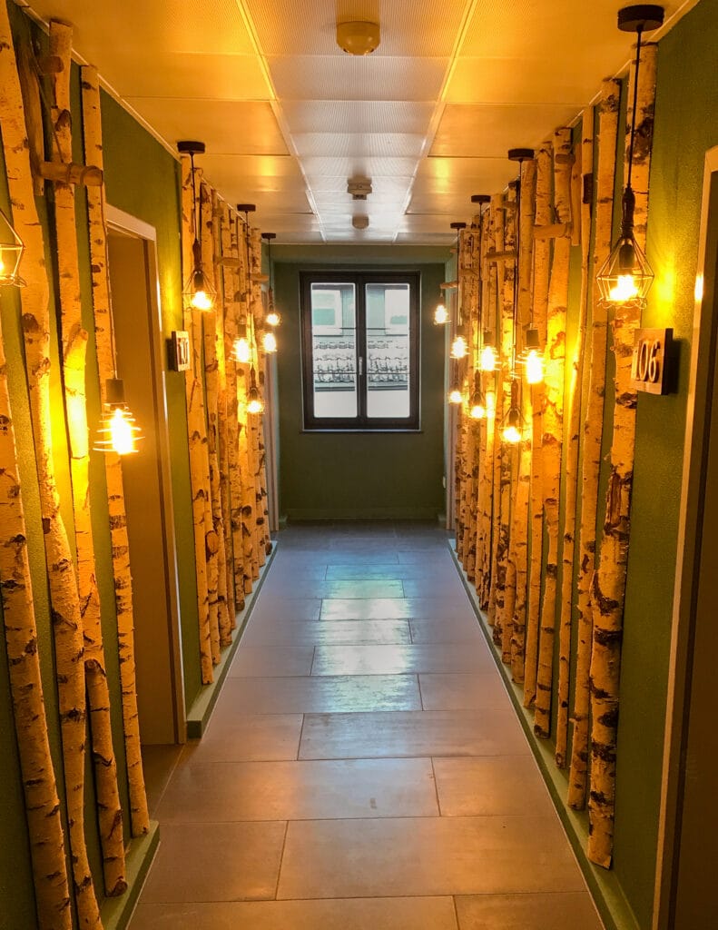 Forest-themed corridor at Hotel Freihof by Stand Out Design - Lara Theel